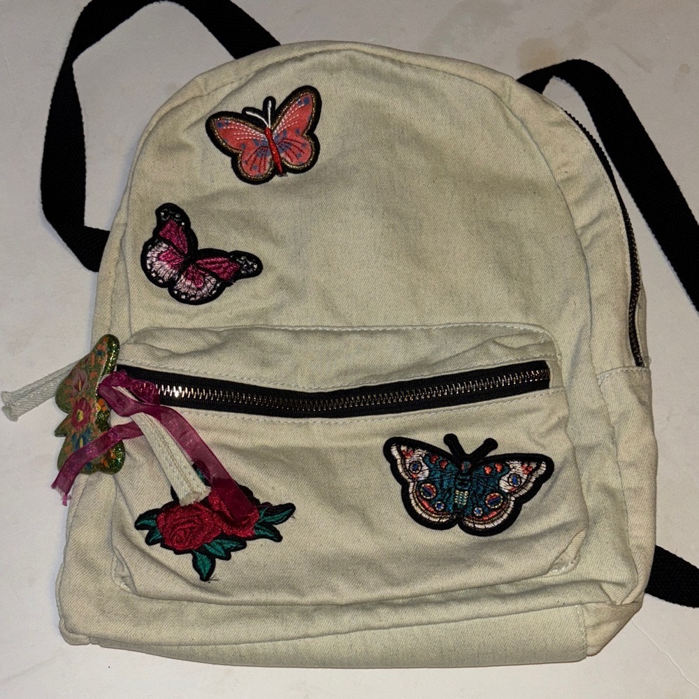 ATMOSPHERE BRAND OFF WHITE DENIM BACKPACK WITH BUTTERFLY PATCH DESIGN  
PRELOVED